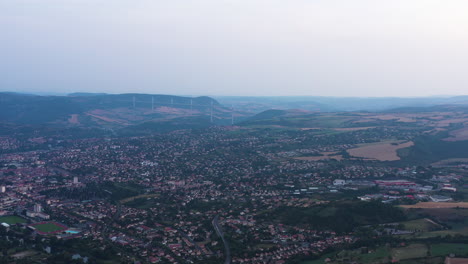 Aerial-cloudy-sunset-over-Millau-with-paragliders-Averyon-France-viaduct